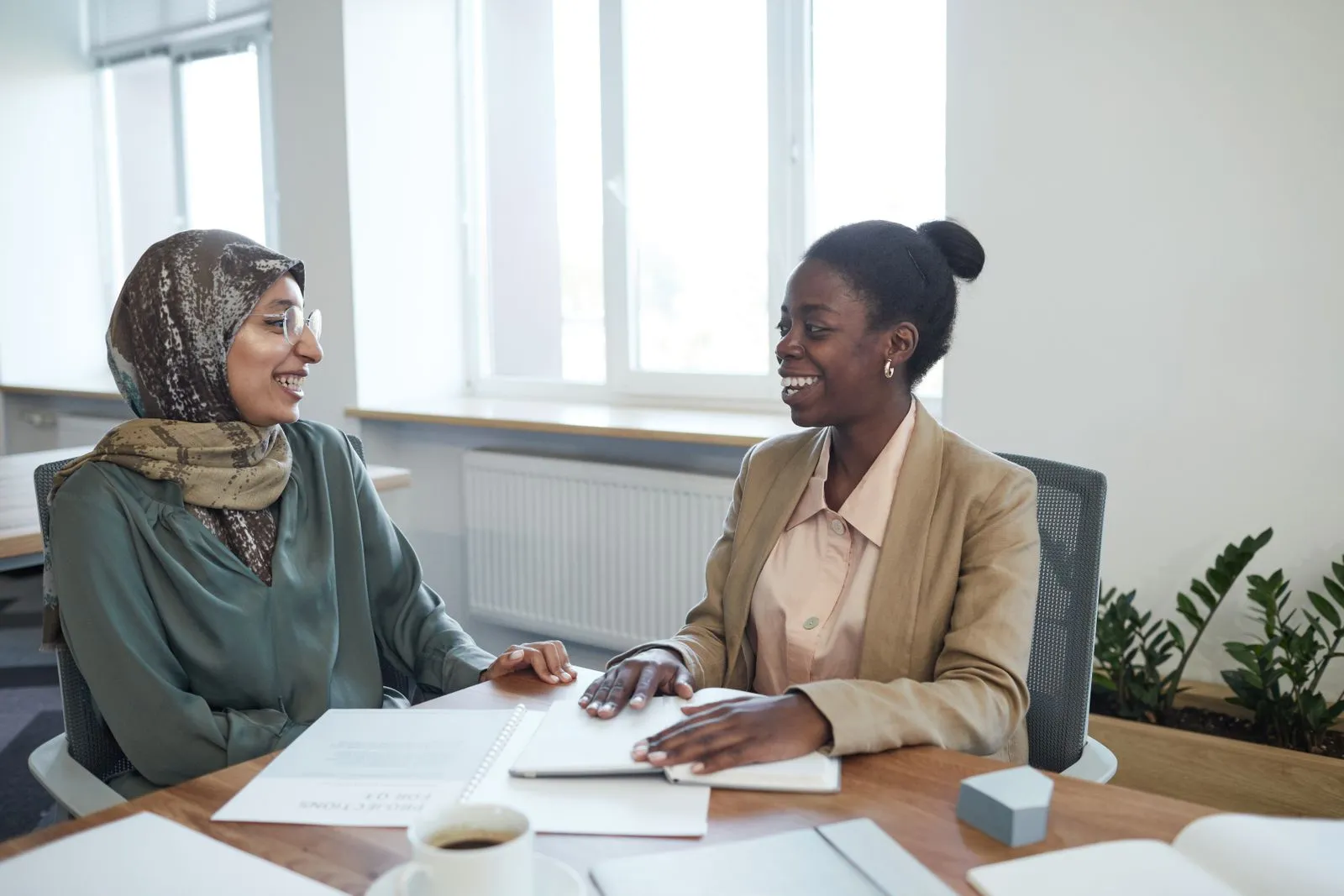 Two professionals in conversation across a table
