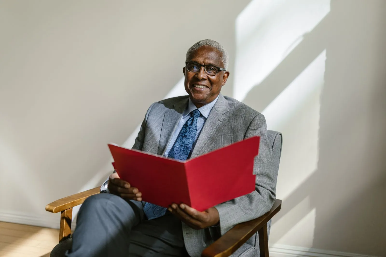 A senior executive seated with a folder