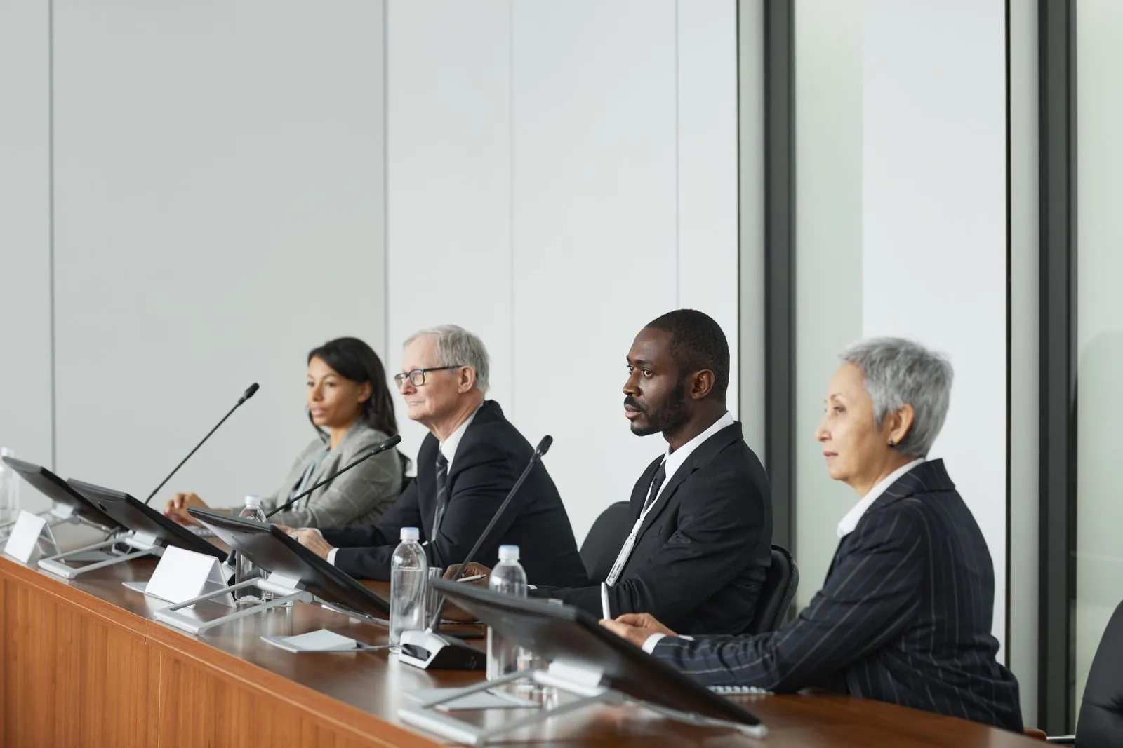 Senior leaders seated at a panel table