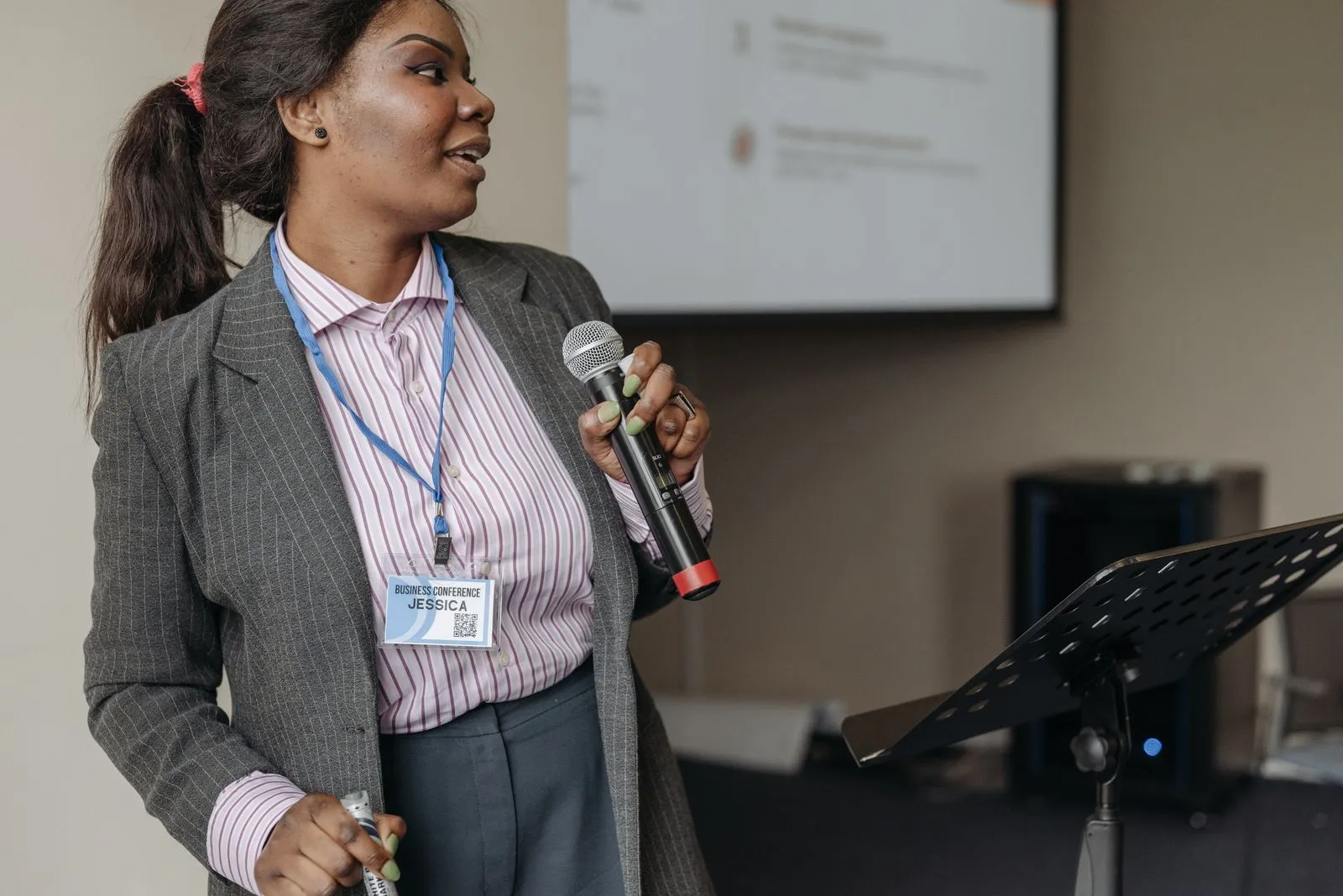 A speaker holding a microphone at an event