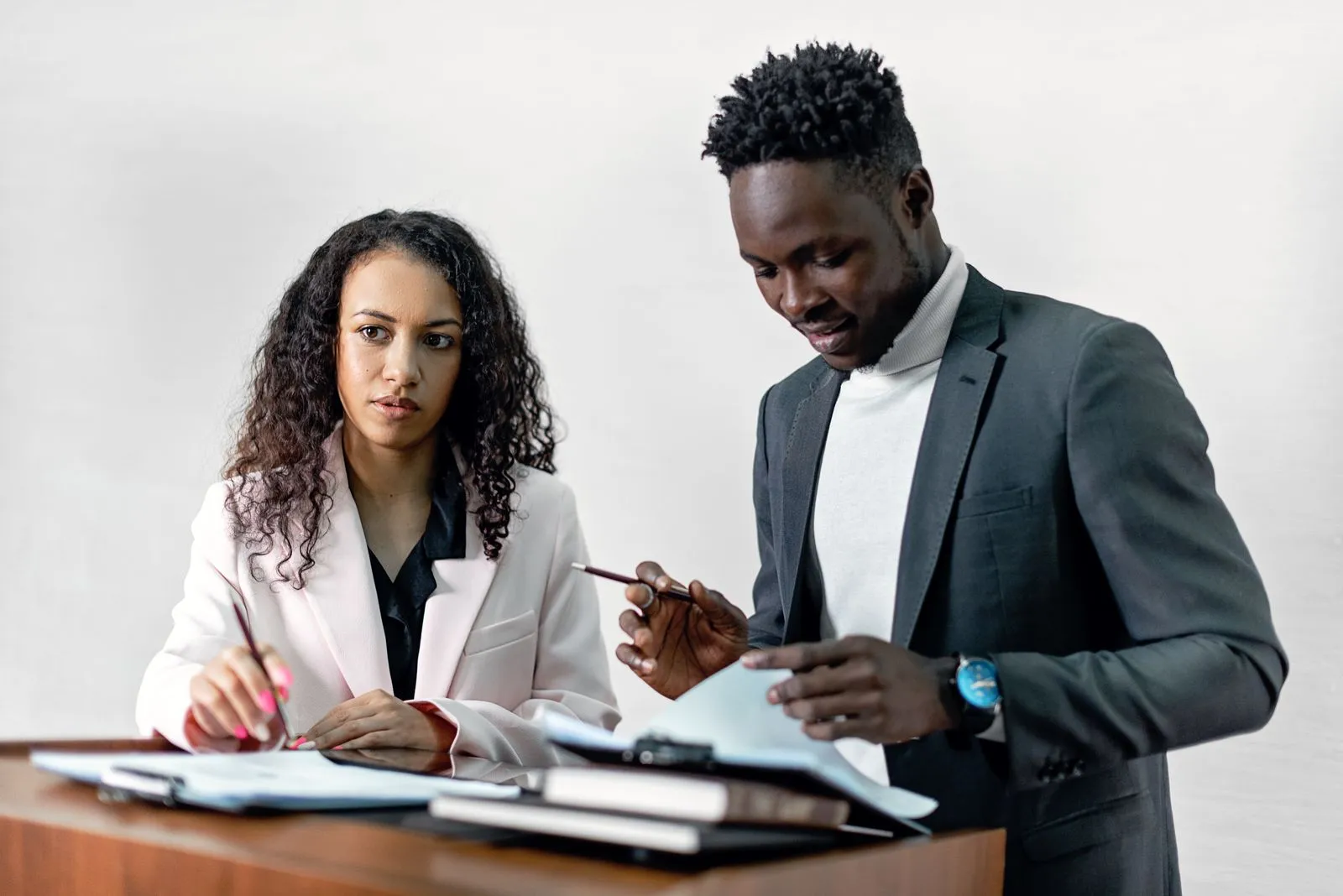 Two colleagues reviewing documents together